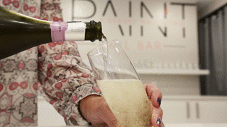A glass of champagne being poured