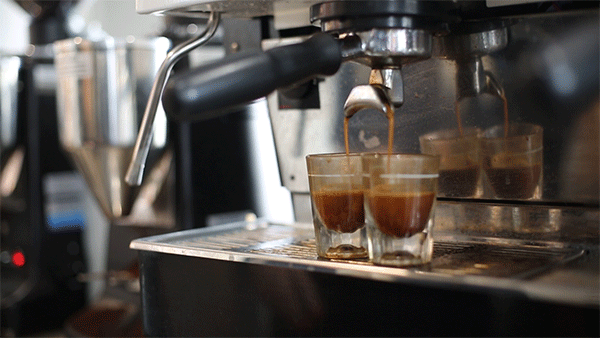 Two shots of espresso being poured 
