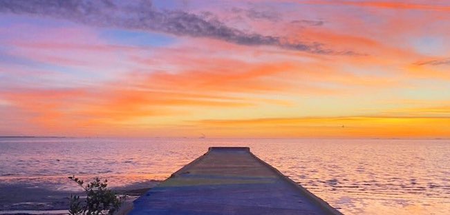 Photo of a Pier Mural at Sunrise 