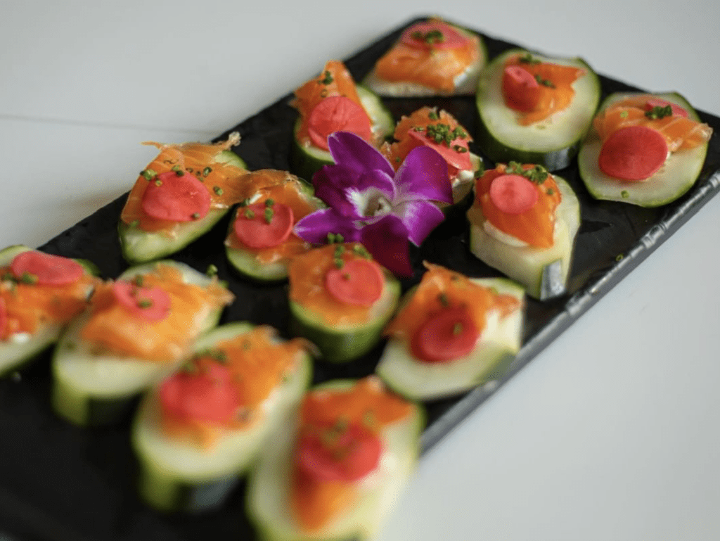 cucumber slices with slices of salmon placed on top.
