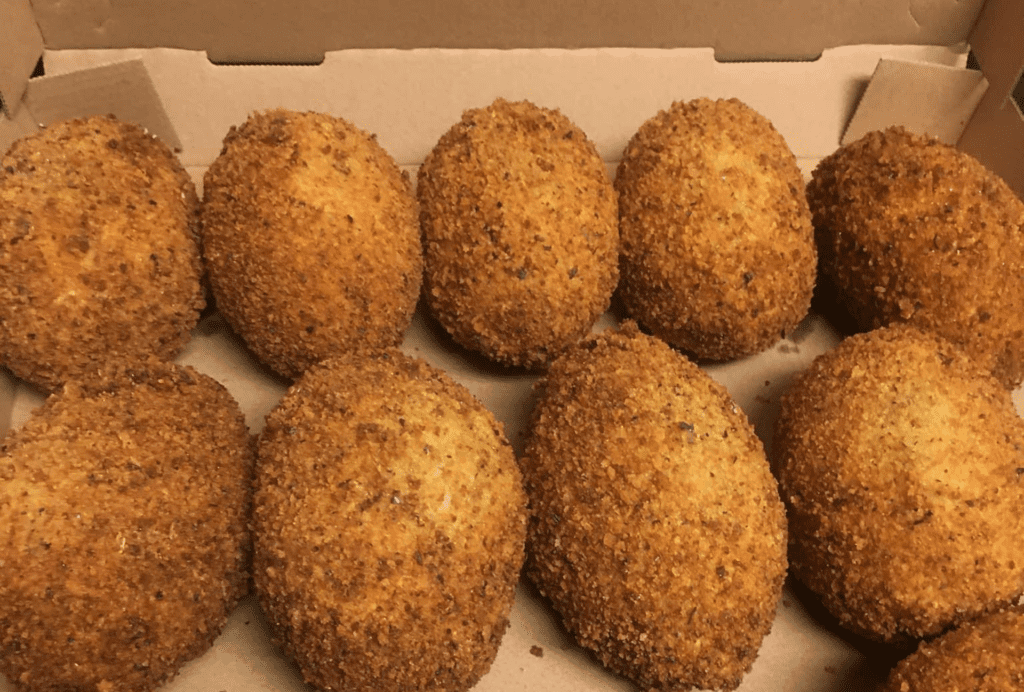 A platter of fried devil crab - breaded balls filled with fresh seafood 